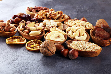 Composition with dried fruits and assorted healthy nuts in wooden bowls