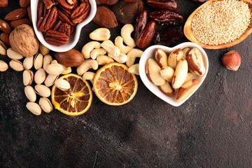 Composition with dried fruits and assorted healthy nuts in wooden bowls