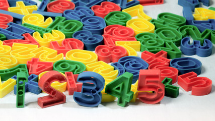 Early Childhood Education, Colorful plastic one to ten number sets in Red, Blue, Green, and Yellow colors. in white background.