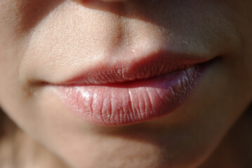 young woman's natural lips close-up in natural light (not studio), outdoors, no any cosmetic...