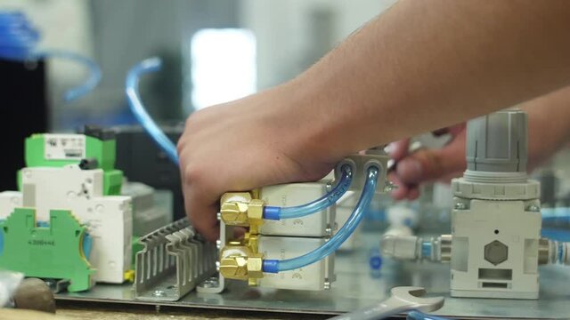 tighten brass nut with wrench in pneumatic automation system