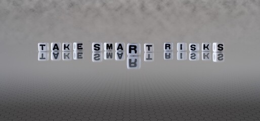 take smart risks concept represented by black and white letter cubes on a grey horizon background stretching to infinity