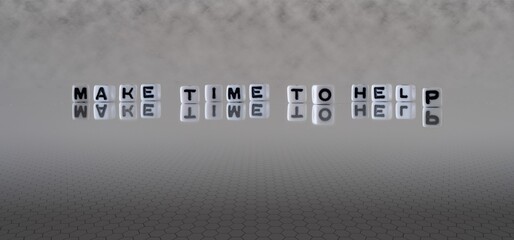 make time to help concept represented by black and white letter cubes on a grey horizon background stretching to infinity