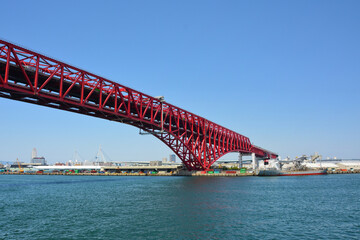 Fototapeta na wymiar Red bridge cross the sea in Osaka