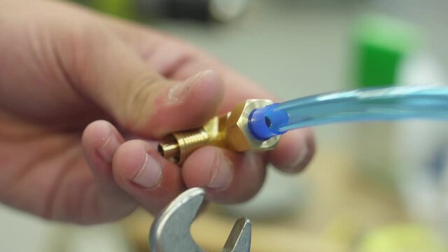 tighten brass nut with wrench in pneumatic automation system
