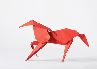 Origami paper art. Red horse on a white background