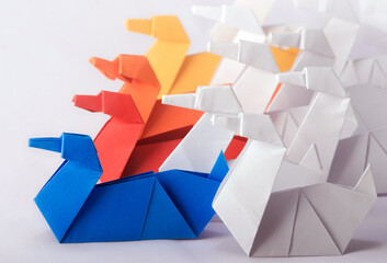 Team Work/Leadership Concept using different color Origami Paper Swans. Achieve goals through collective efforts of a team  
