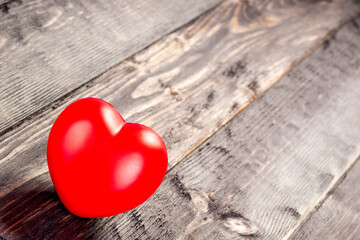 Love concept, red heart object on a wooden table close-up