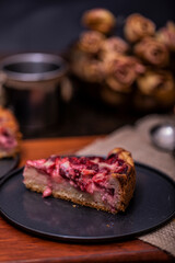Strawberries cake tart with strawberries and whipped cream decorated with dark background. Soft focus, delicious view.