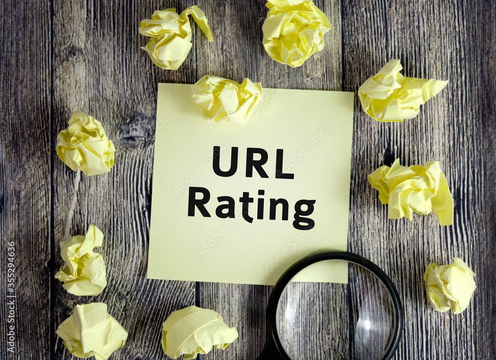 Poster url rating seo concept - text on yellow note sheets on a dark wooden background with crumpled sheets
