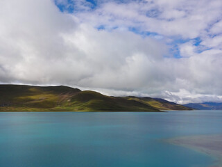 White clouds covers the mountain and lake in Tibet