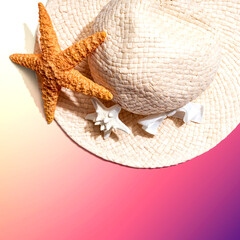 Fototapeta na wymiar Summer concept with a straw hat and starfish overhead view - flat lay
