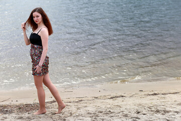 A girl at the river shore in spring