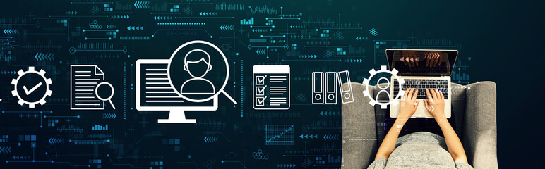 Document management system concept with person using a laptop in a chair