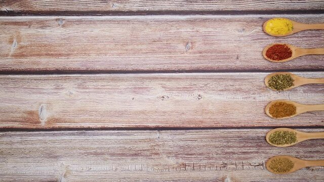 Wooden spoons appear on right side and various kind of spices appear in them - Stop motion 