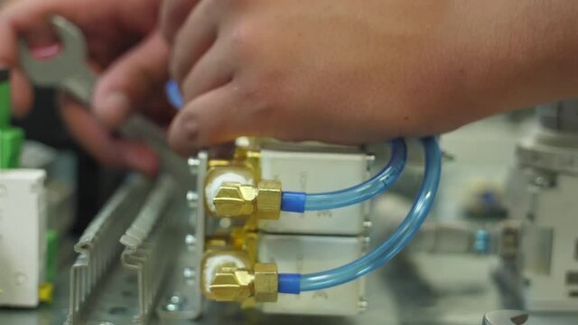 tighten brass nut with wrench in pneumatic automation system