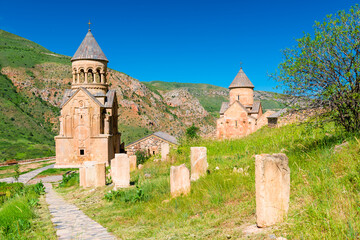 Fototapeta na wymiar The territory of the Orthodox monastery Noravank in the summer morning at the red rock, a famous landmark of Armenia