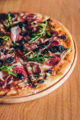 Delicious italian pizza served on wooden table on the pizza board