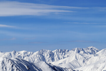 High snowy mountains and blue sky with clouds