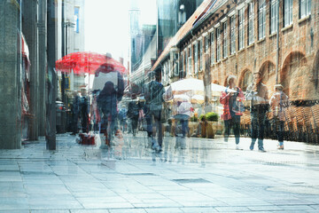 Abstract city life, people are walking and shopping in the pedestrian zone in the old town, multiple exposure and motion blur, copy space - obrazy, fototapety, plakaty
