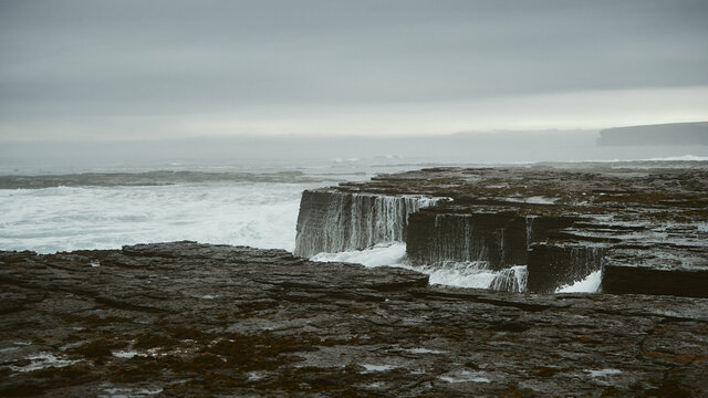 water receding after waves break on rocks