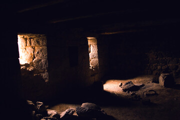 Light entering through open door to a dark empty room