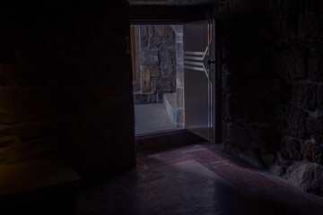 Fototapeta na wymiar Light entering through open door to a dark empty room
