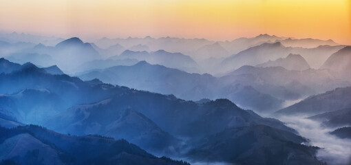 Predawn time in the highlands. mountain silhouettes in the fog