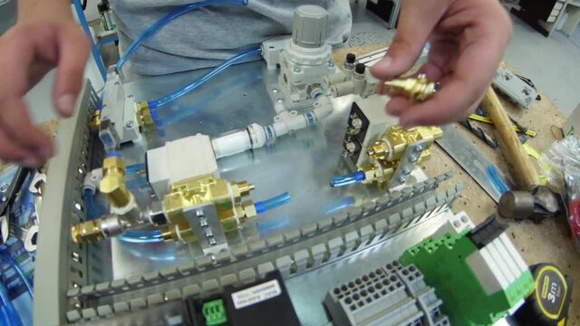 tighten brass nut with wrench in pneumatic automation system slow motion