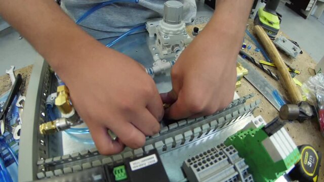 tighten brass nut with wrench in pneumatic automation system slow motion
