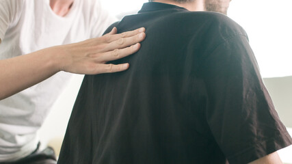 Physiotherapist exercising with disabled person on a therapy table.