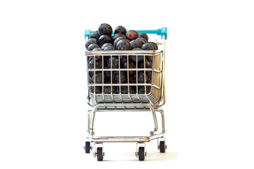 Small metal shopping cart full of fresh juicy blueberries on a white background. Concept fresh...
