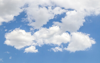 White clouds against the blue sky. Template for wallpaper, stretch ceilings