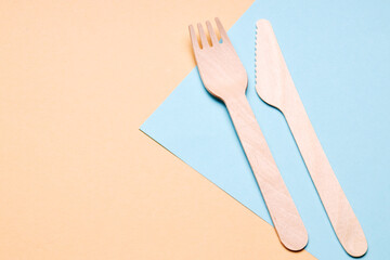 eco-friendly disposable utensils concept. bamboo or wooden cutlery over color background.