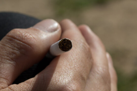 Man heand holding a cigarette