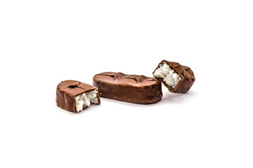 Chocolate bars on a white background. Chocolate candies with coconut flakes close-up.