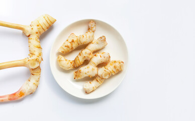 Fresh galangal isolated on white.