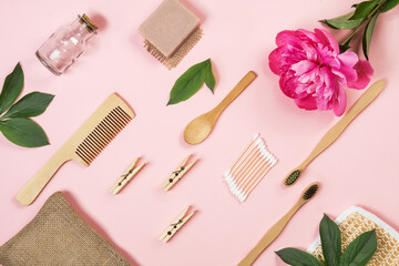 Zero waste bathroom accessories, bamboo toothbrush, wooden comb, handmade solid soap, tooth powder, washcloth made of natural herbs Modern sustainable lifestyle concept. Flat lay style.