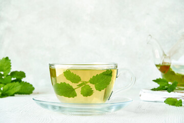 Fresh natural melissa , lemon balm herbal tea in glass cup.	