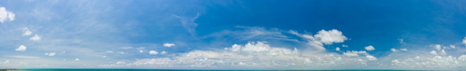 Fototapeta na wymiar Beautiful sky panorama with slight ocean and land on bottom of frame