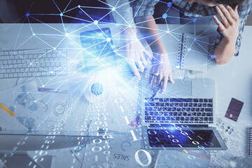 Double exposure of man and woman working together and data theme hologram drawing. Computer background. Top View.