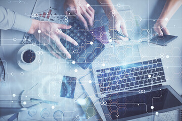 Double exposure of man and woman working together and data theme hologram drawing. Computer...
