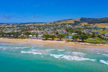 People are enjoying a sunny day on a beach at Apollo Bay, Australia