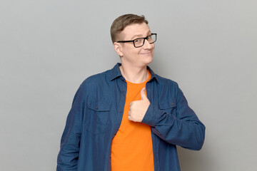 Portrait of happy man raising thumb up in approval and like gesture