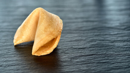 fortune cookie on a dark surface Copy space
