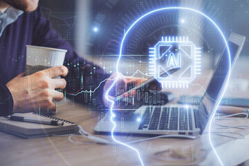 Double exposure of man's hand holding and using a digital device and brain hologram drawing. Data...