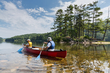 father and son canoeing in a lake 