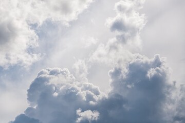 Gray and white fluffy clouds in the pale sky. Beautiful sky