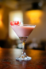 Making cocktails at home like an expert nightclub barman. Fresh and juicy colorful homemade cocktails garnished with friuts, mint and coffee on interior background.