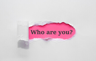 Who are you question written under torn paper.